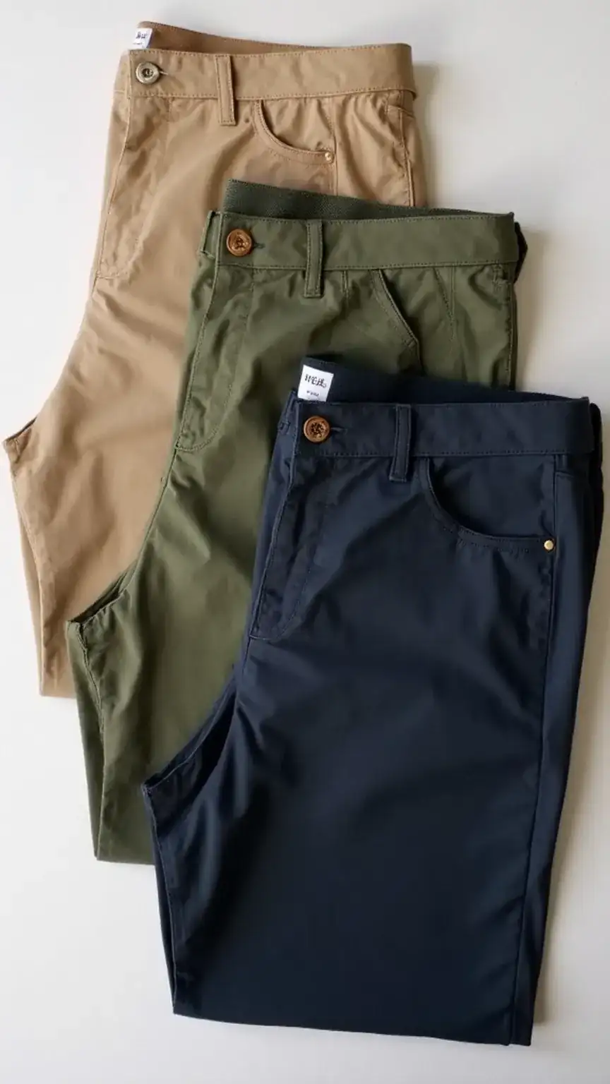 Men's lightweight pants for fall transition, beige chinos, olive trousers, navy pants, ditching shorts for autumn style, seasonal men's fashion.