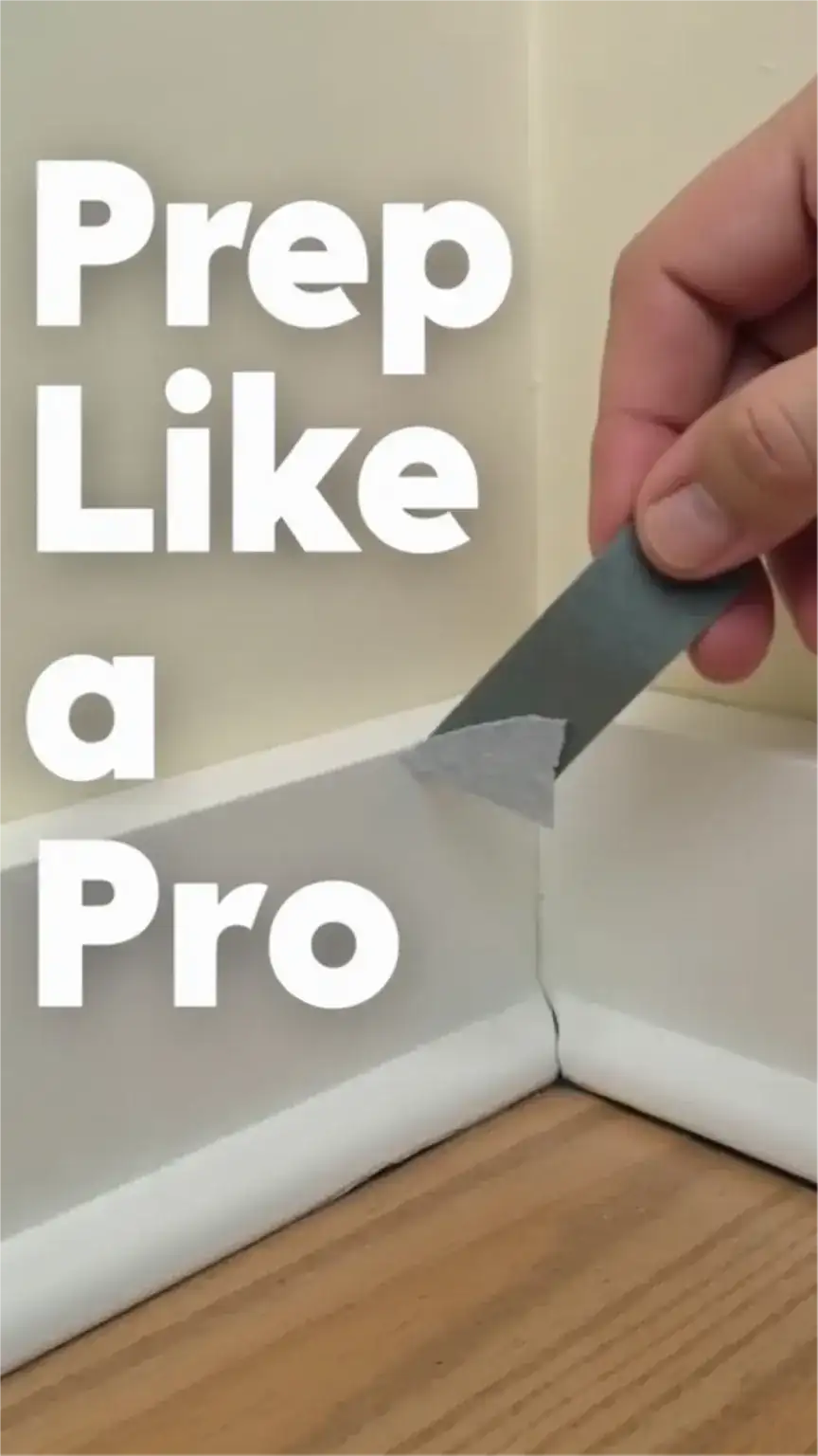 Applying painter's tape to baseboards for clean lines during room painting, DIY prep work, essential painting tips, masking trim.